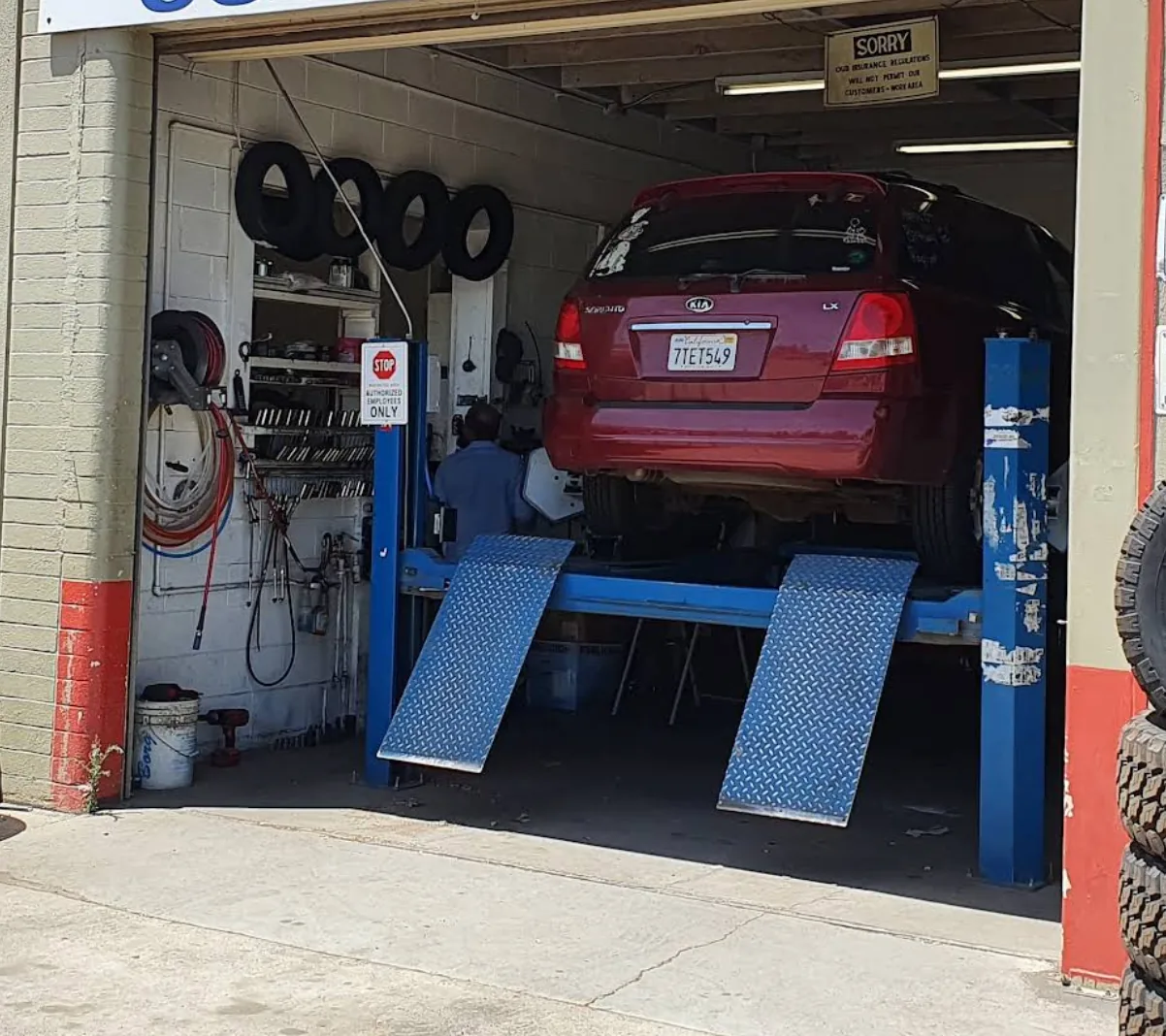 SUV up on the alignment rack in the 99 Express Wheels service bay